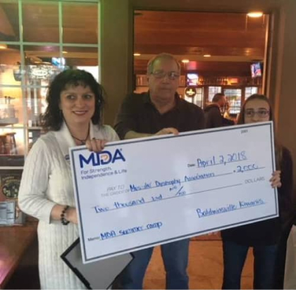 Baldwinsville Kiwanis Club member John Penny presents donation to the Muscular Dystrophy Association